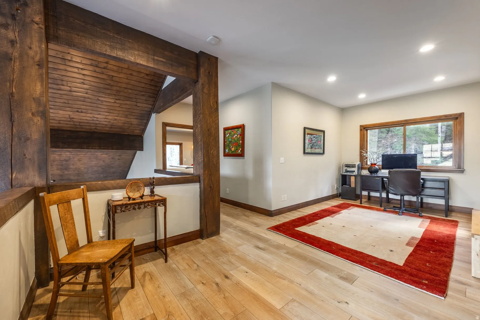 Open concept space featuring wood-finish flooring, recessed lighting, and exposed timber beams