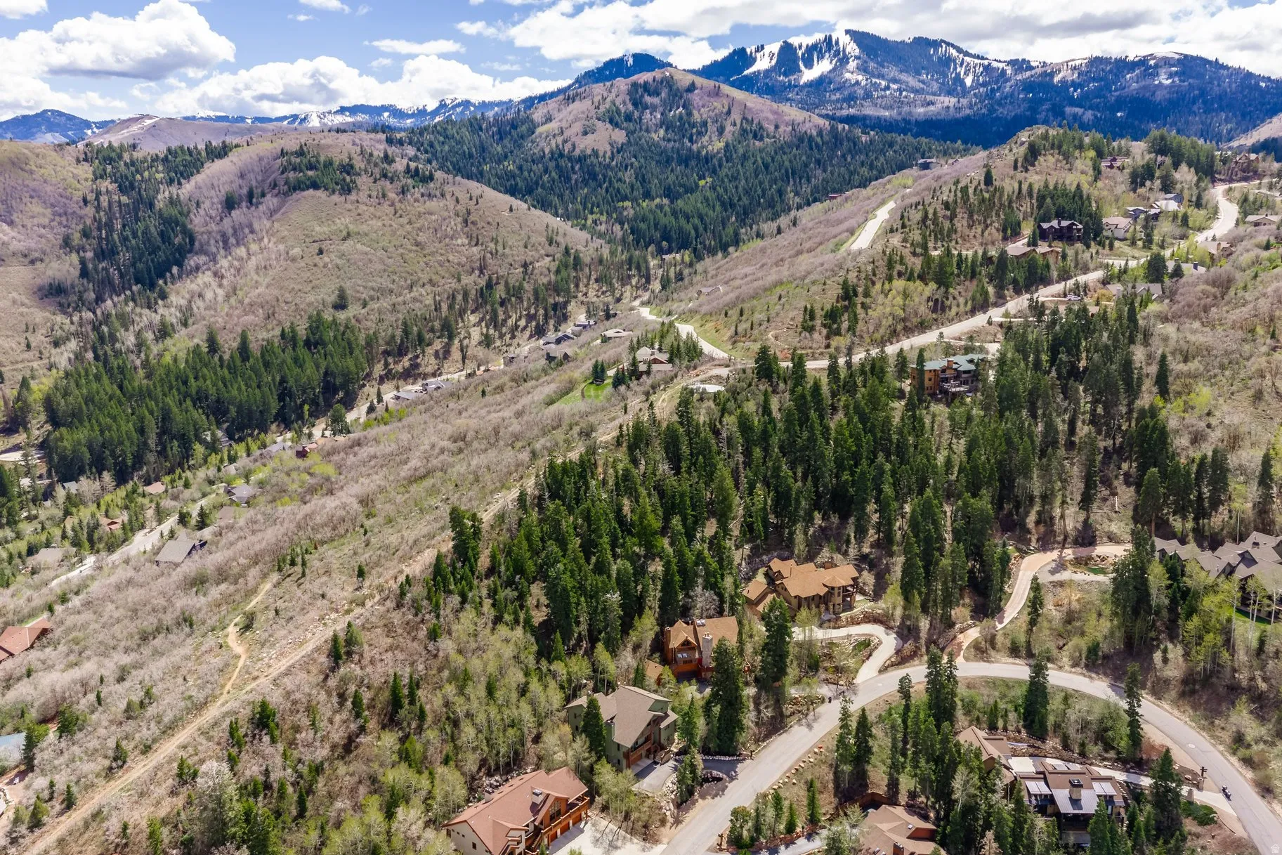 Aerial perspective showcasing mountainous terrain with scattered residences