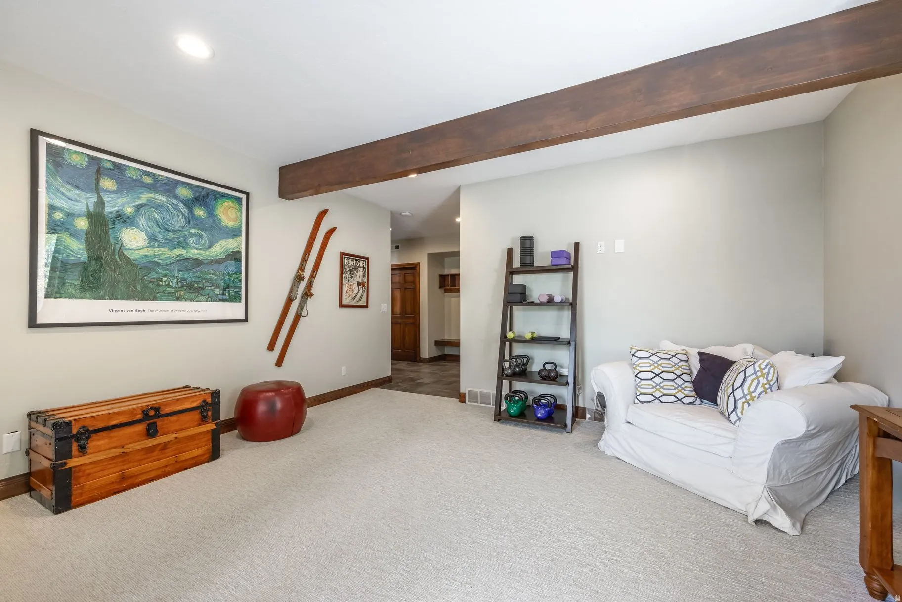 Carpeted room with a dark wood-finish ceiling beam, recessed lighting, and light-toned wall paint