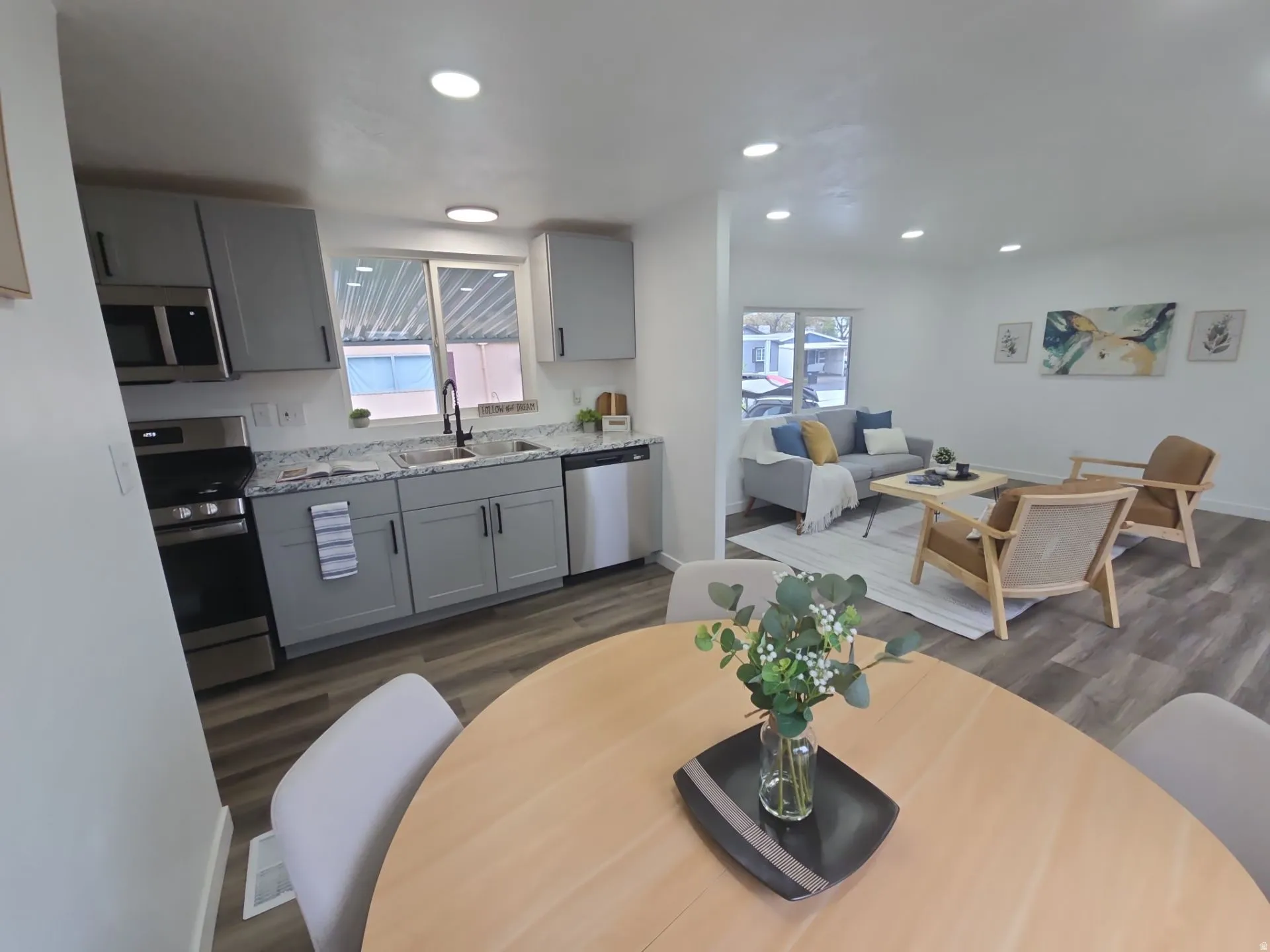 Dining room with dark wood finished floors and recessed lighting
