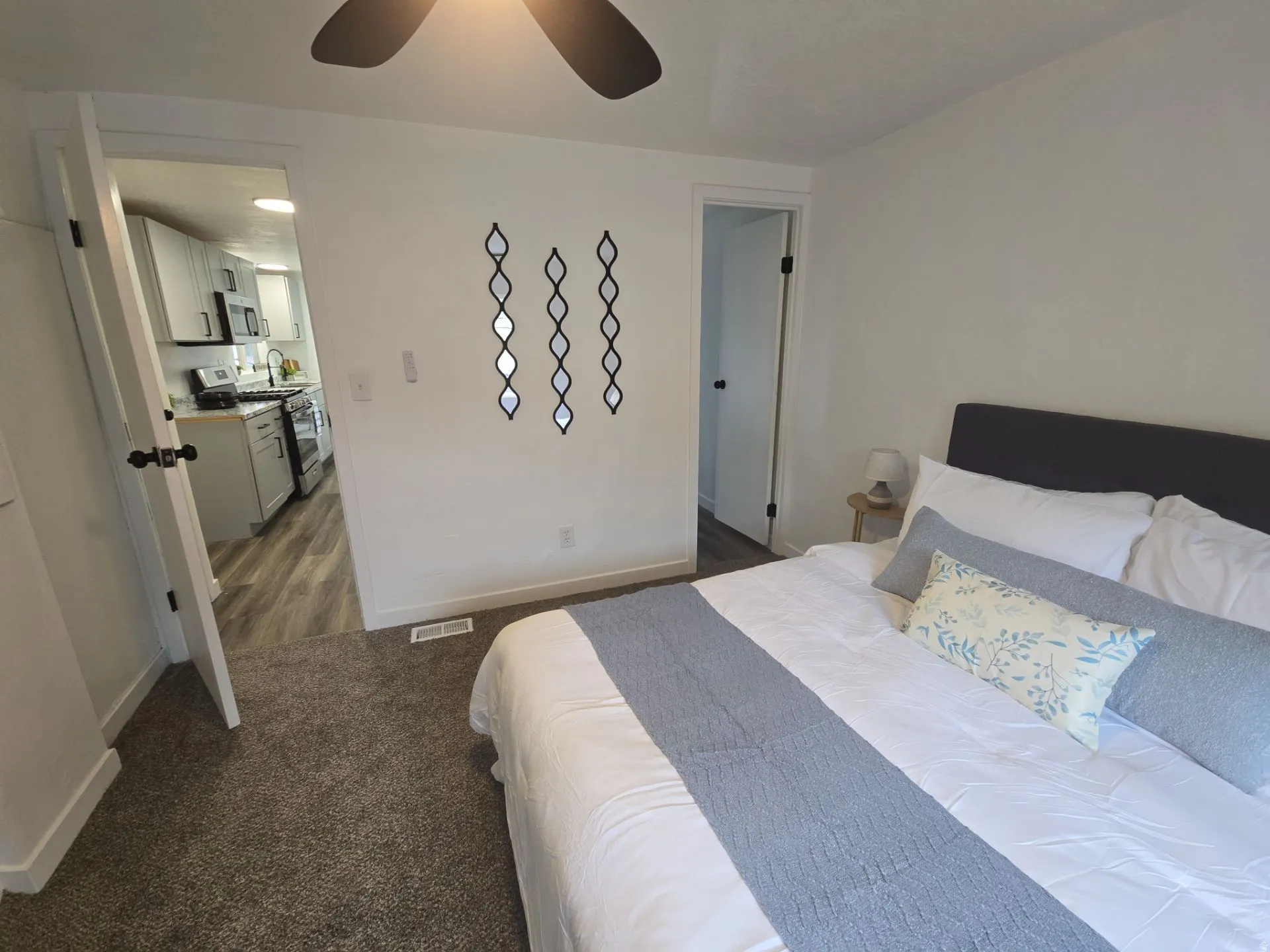 Bedroom featuring dark carpet and ceiling fan