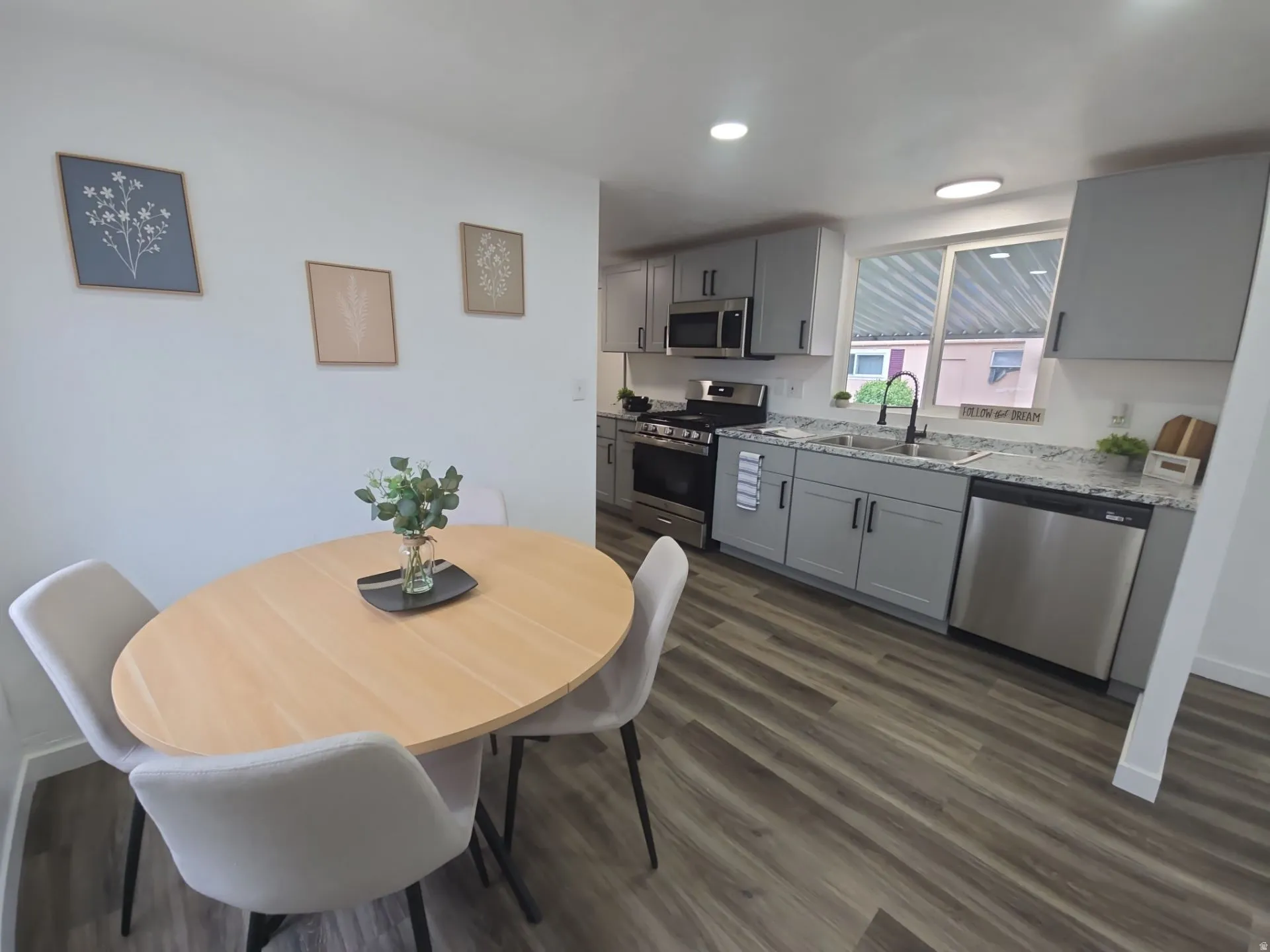 Dining room featuring dark wood-style flooring and recessed lighting