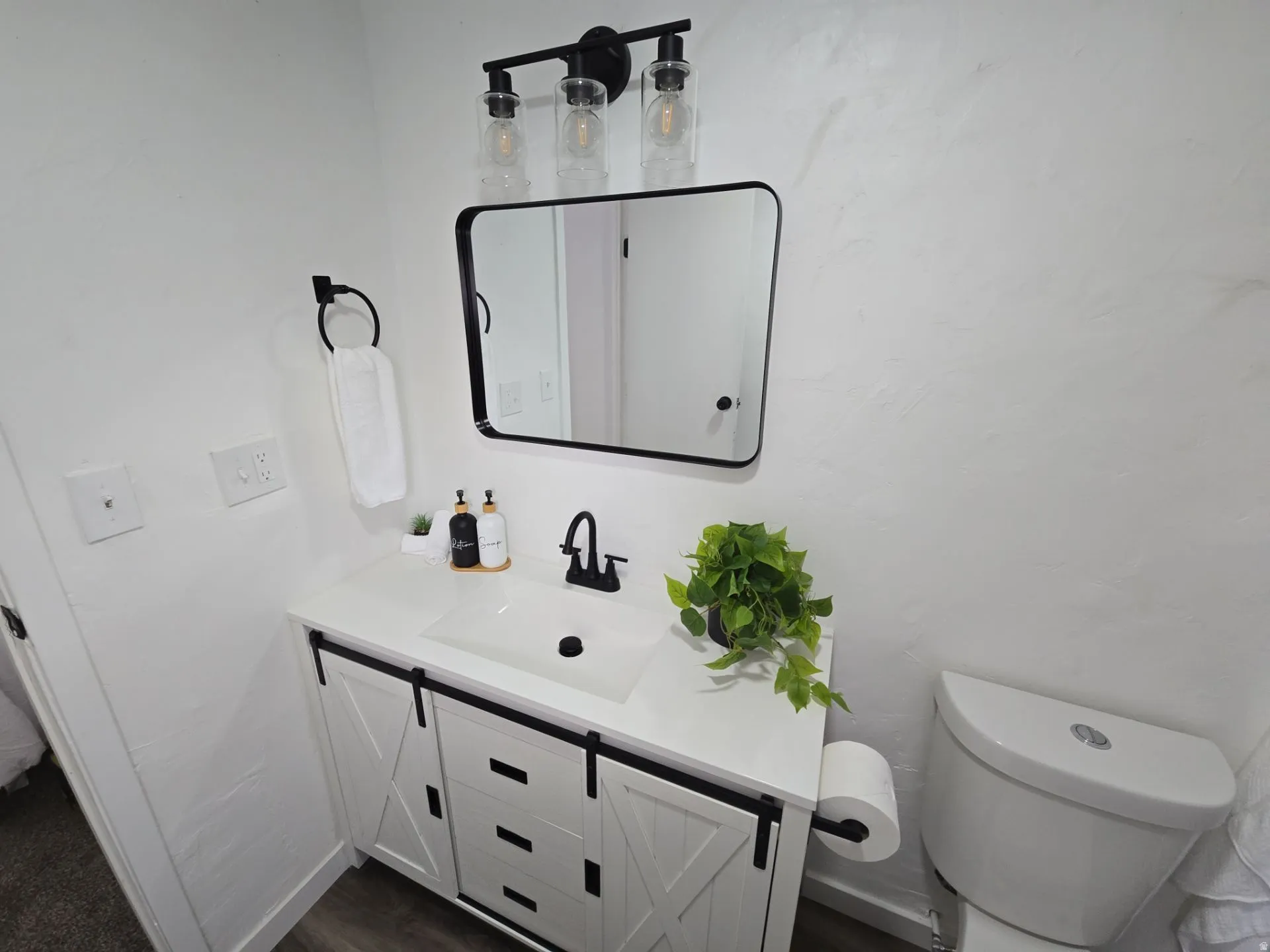 Bathroom featuring vanity and dark wood finished floors