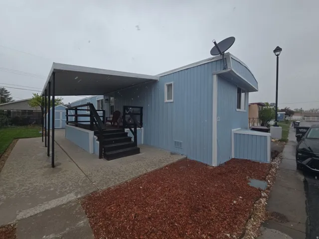 Back of house featuring a patio area, an outbuilding, and crawl space