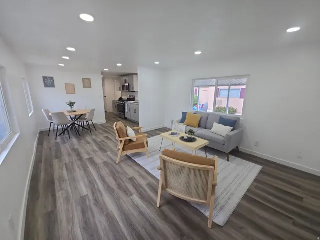 Living room with dark wood-style floors and recessed lighting