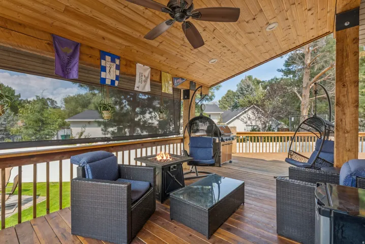 Deck featuring an outdoor fire pit and ceiling fan