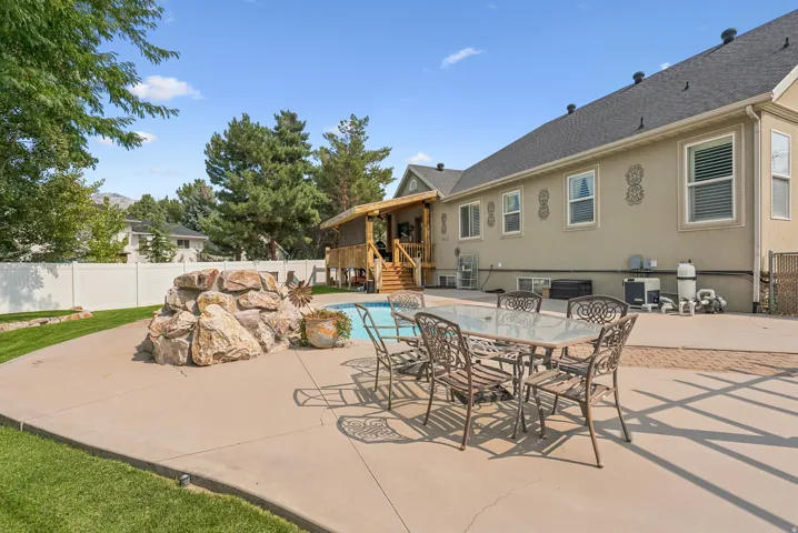 View of swimming pool featuring patio surround, a fenced backyard, and outdoor dining area