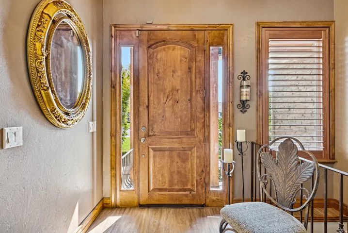 Foyer with light wood-style floors and a textured wall