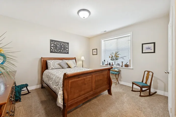Carpeted bedroom with baseboards