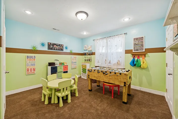 Playroom with dark carpet and baseboards
