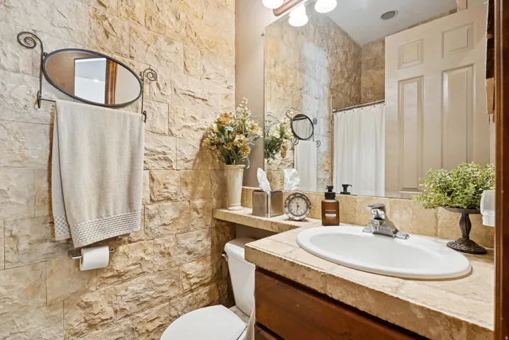 Full bath with a shower with shower curtain and vanity