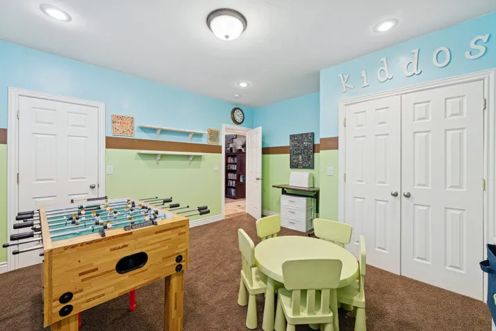 Rec room with dark carpet and baseboards