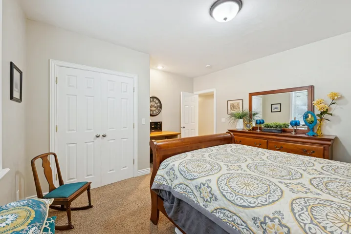 Bedroom with a closet and light colored carpet