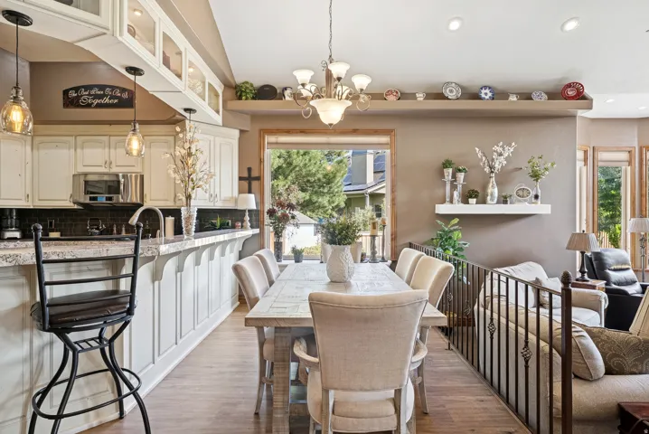 Dining room with suspended lighting and light wood-type flooring