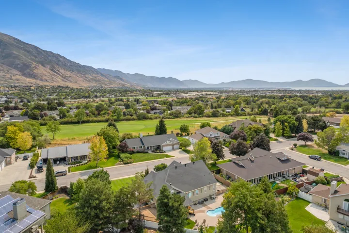 Aerial view of residential area with mountains and a local golf course