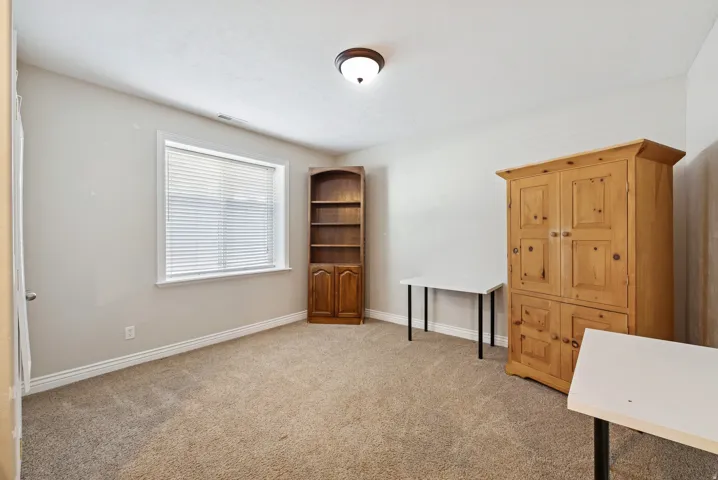 Unfurnished office with light carpet and baseboards