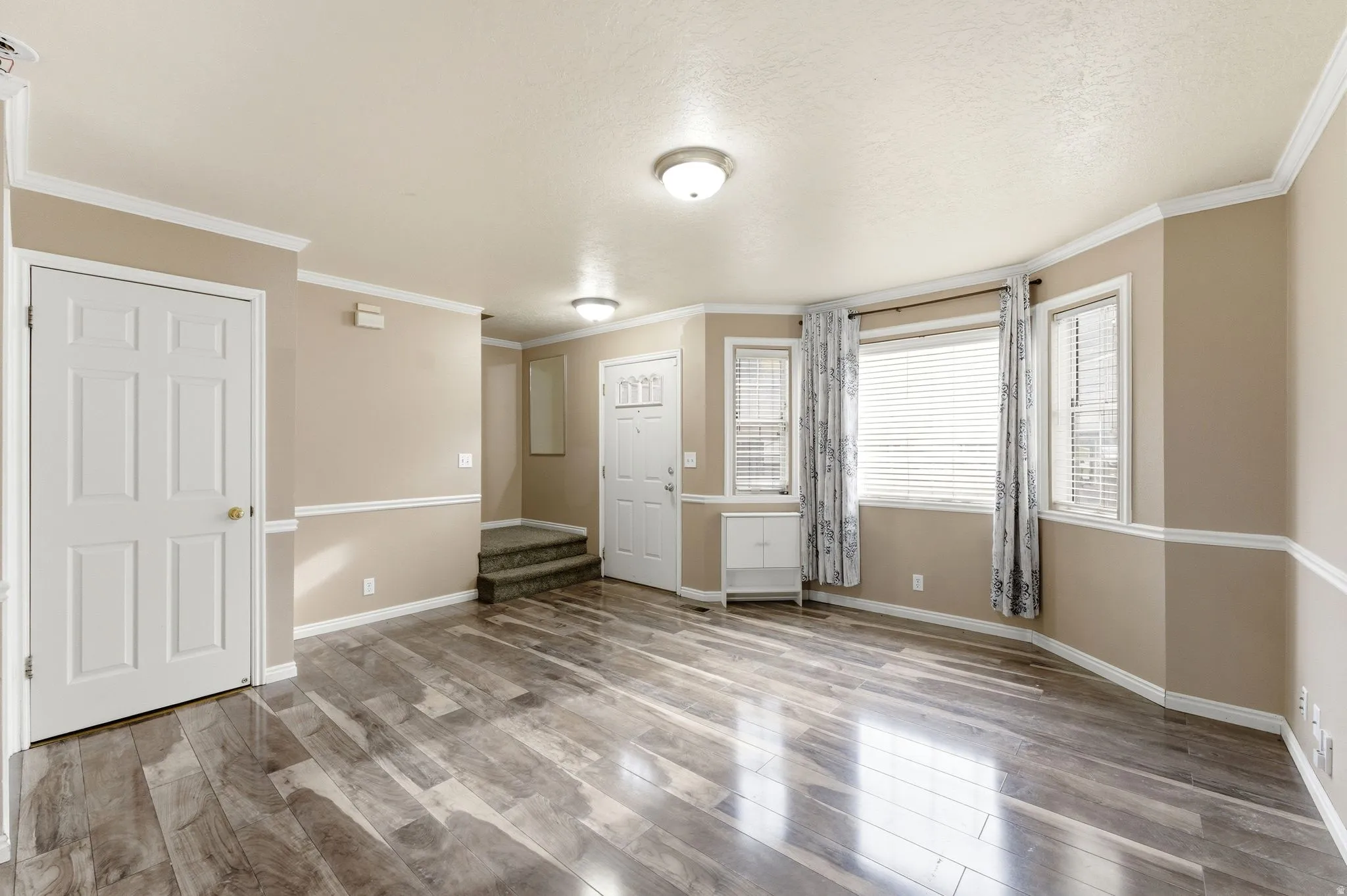 Unfurnished bedroom featuring light wood-style flooring and ornamental molding