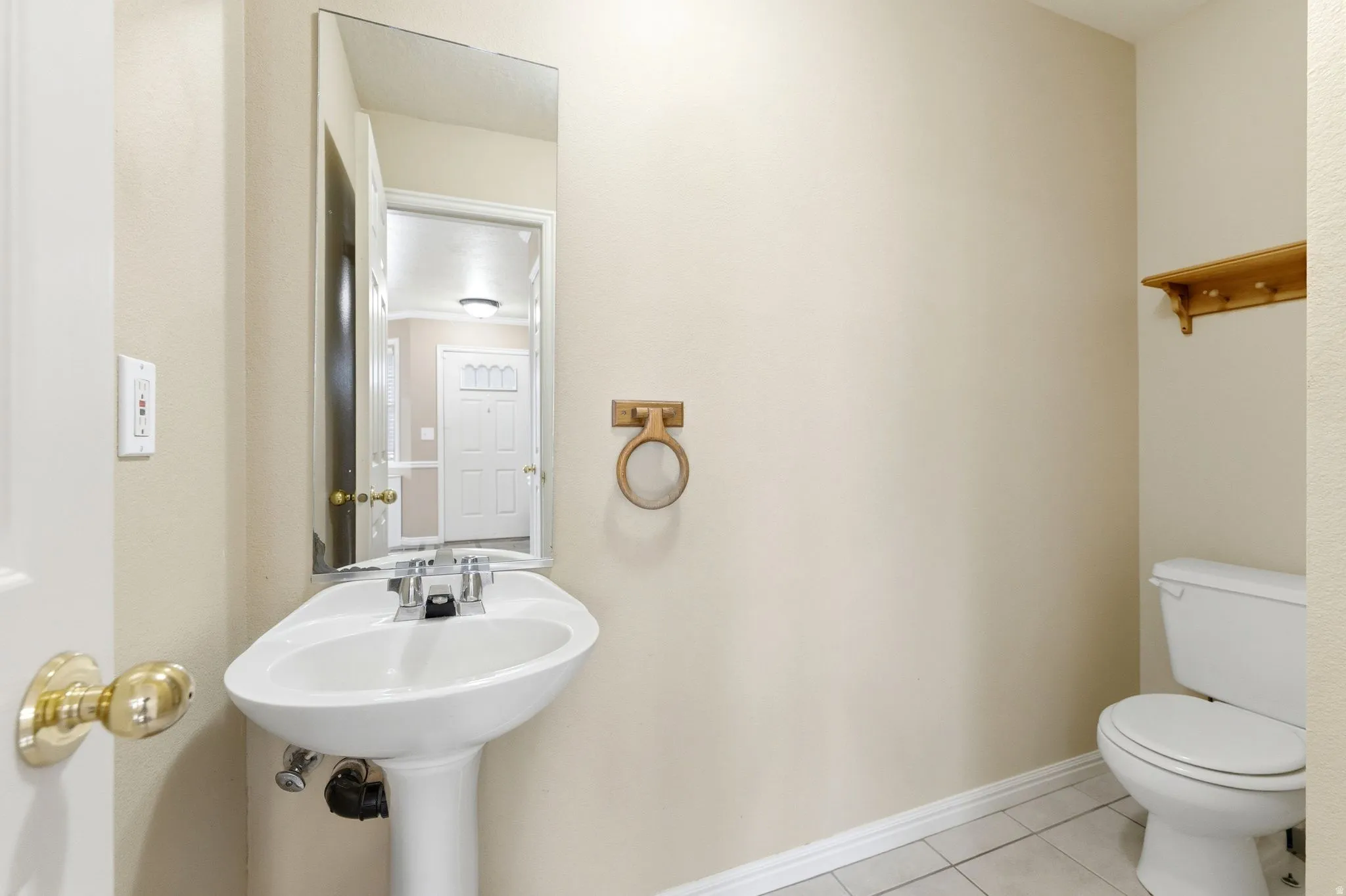 Bathroom with toilet and light tile patterned flooring