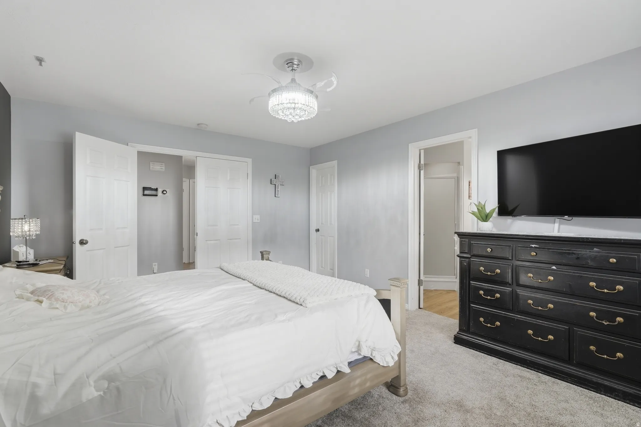 Bedroom with light carpet and ensuite bathroom