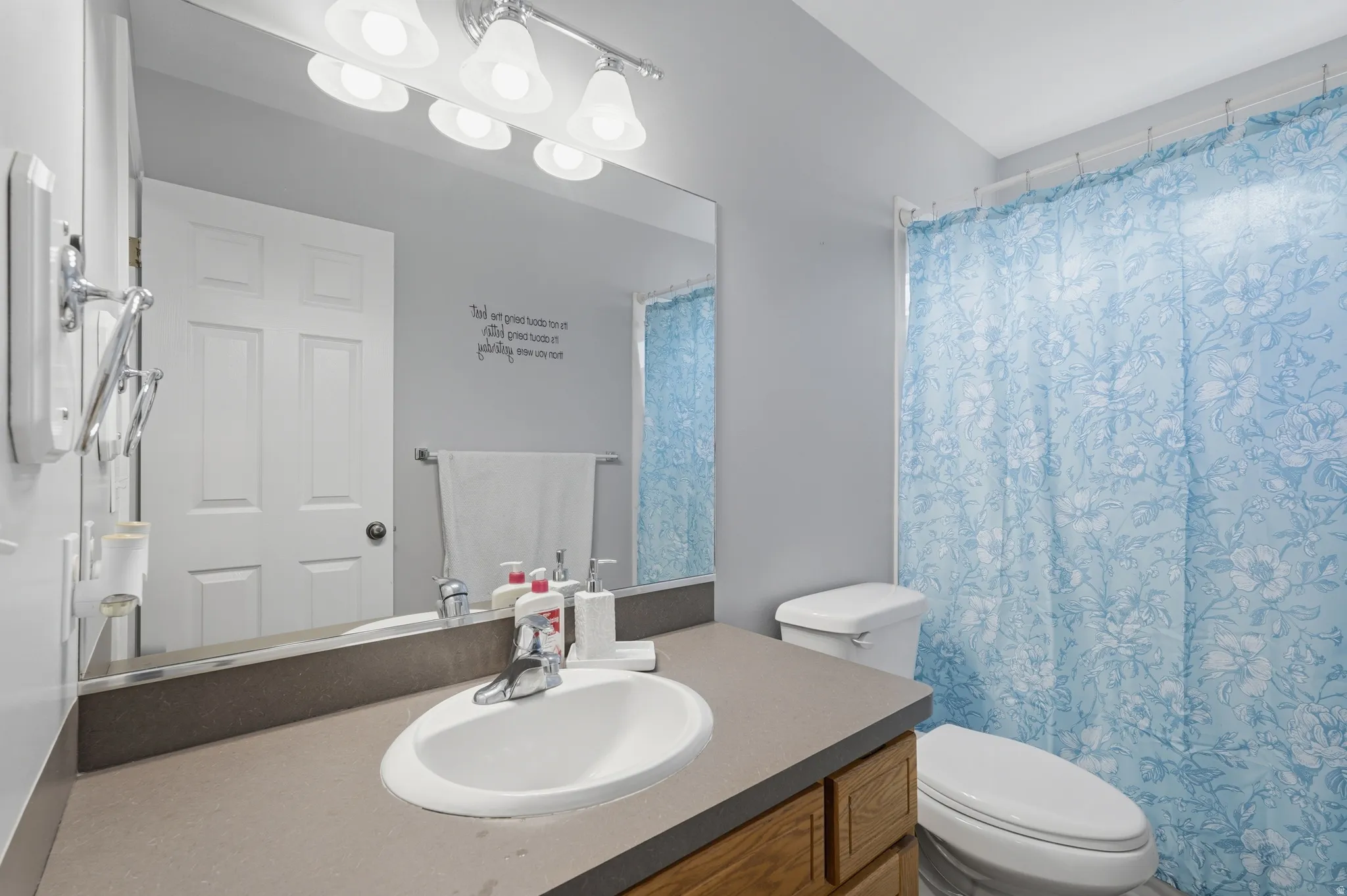 Bathroom with vanity and curtained shower