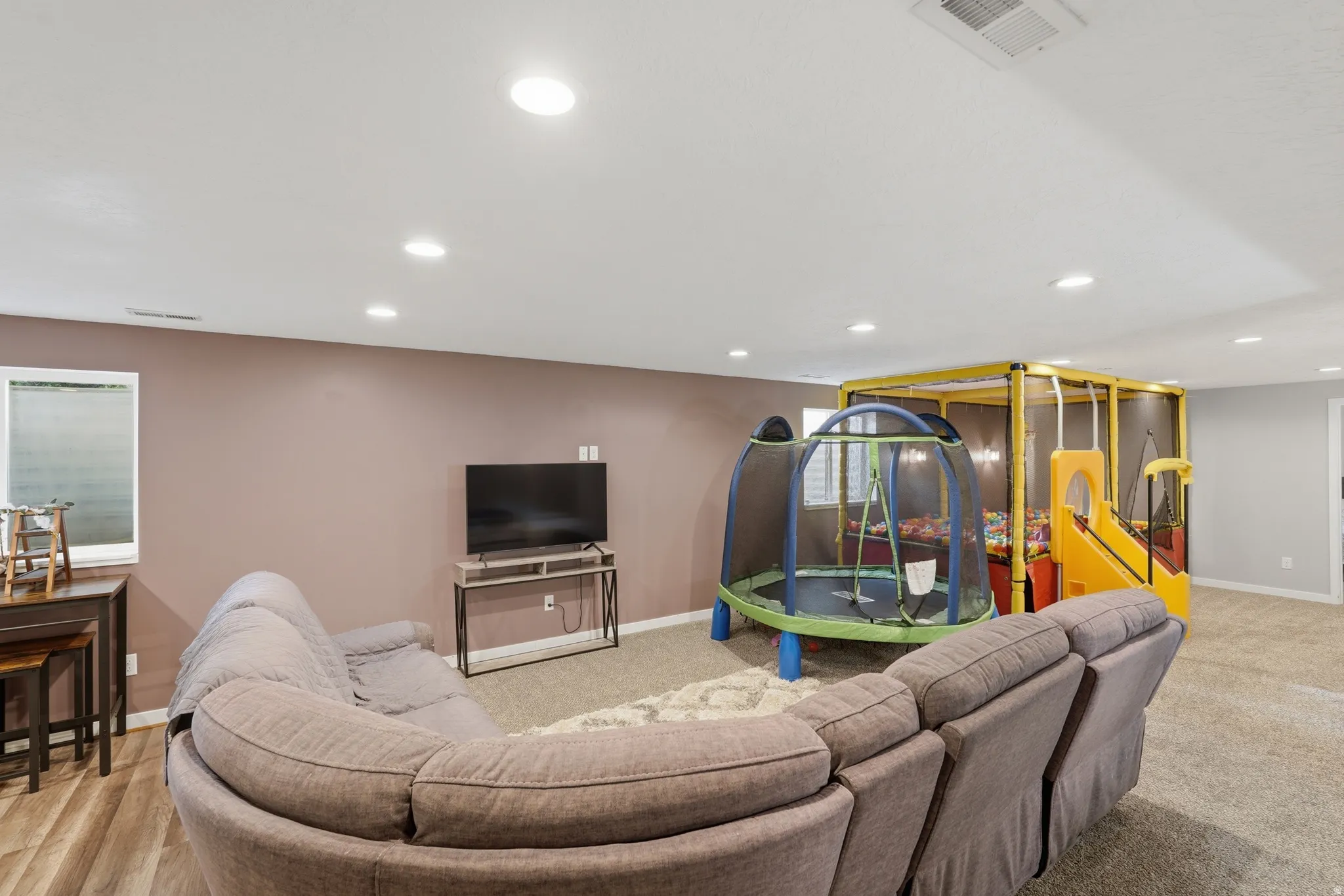 Living room with recessed lighting and baseboards