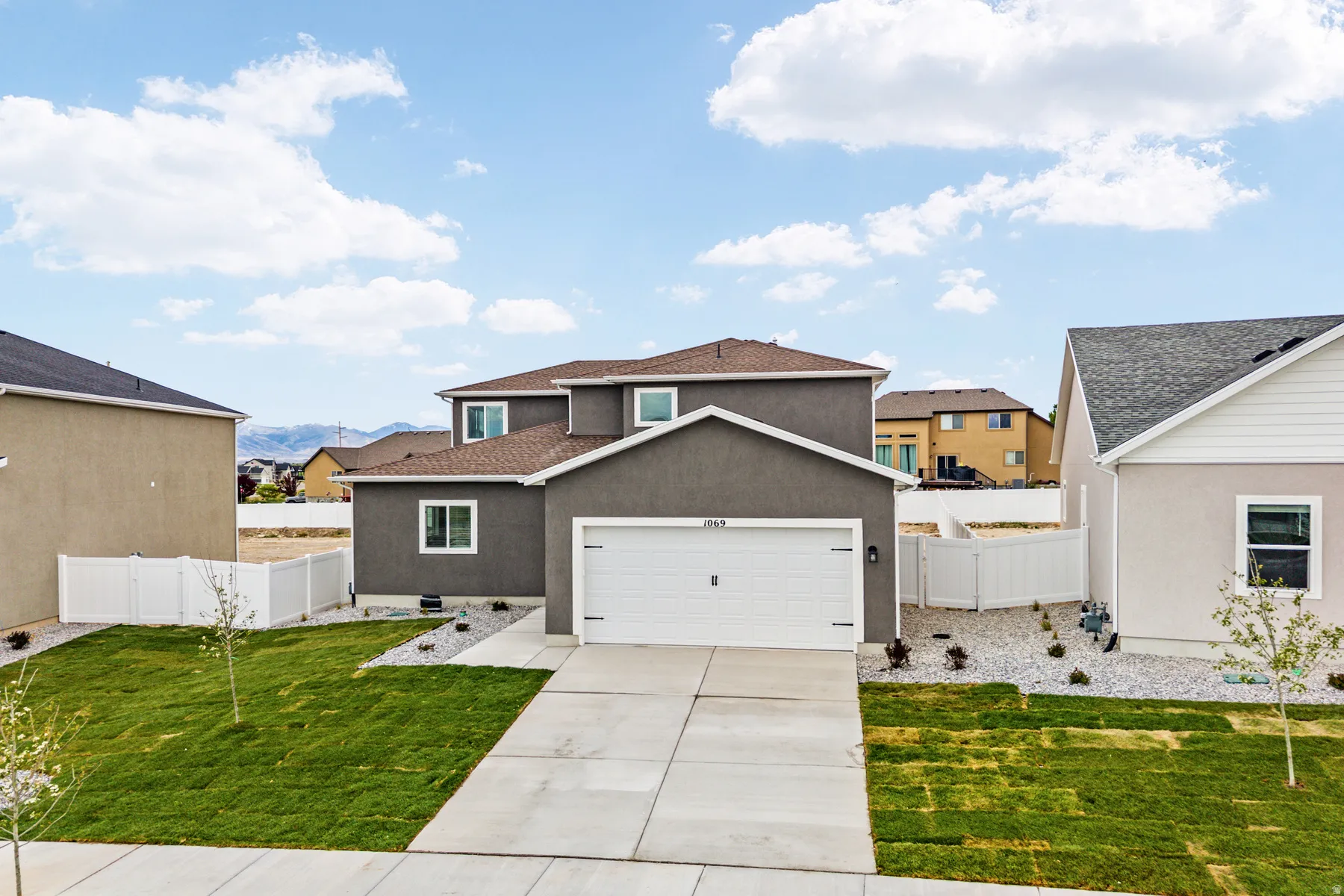 Contemporary two-story residence featuring a stucco exterior and an attached two-car garage