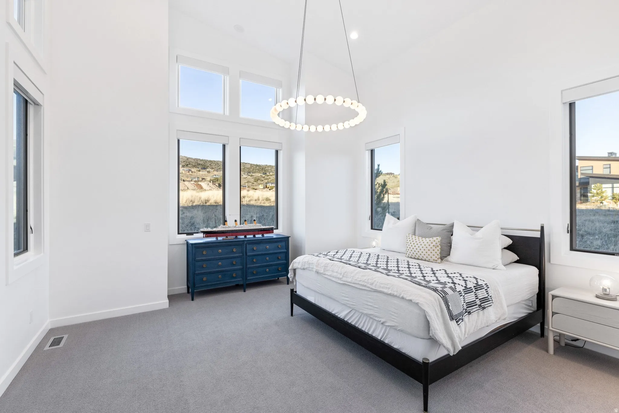 Carpeted bedroom featuring a high ceiling and recessed lighting
