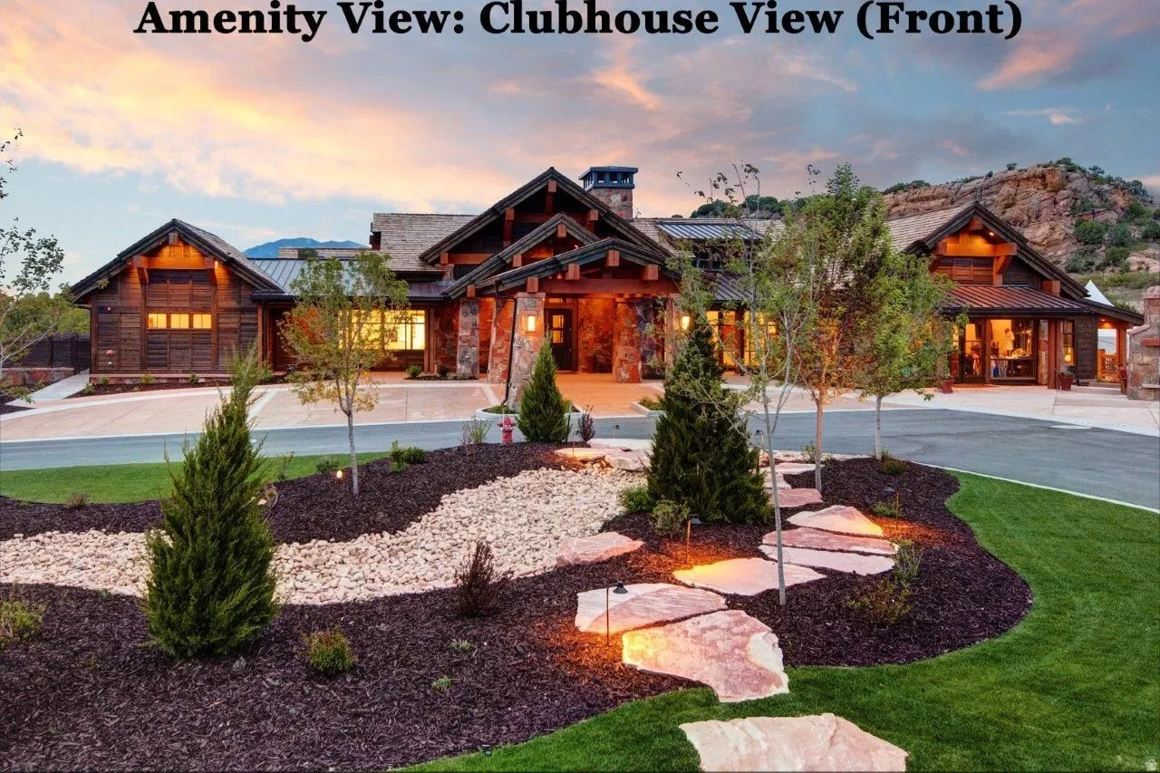 View of front of home featuring a standing seam roof, stone siding, and a chimney