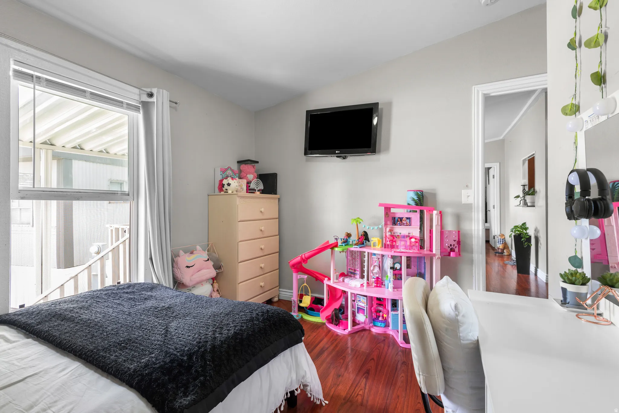 Bedroom featuring dark wood-style flooring and lofted ceiling