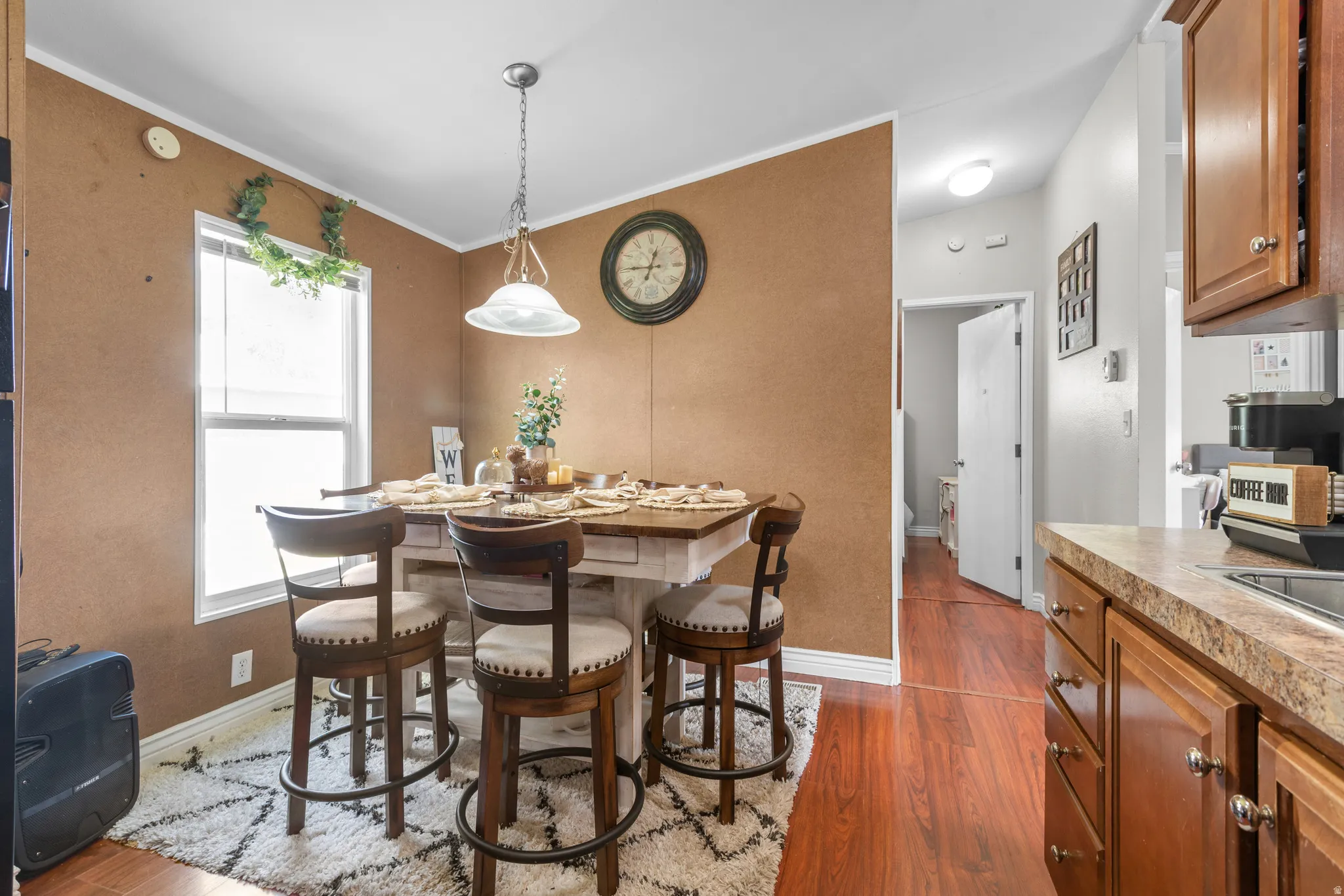 Dining room featuring dark wood-style flooring and ornamental molding