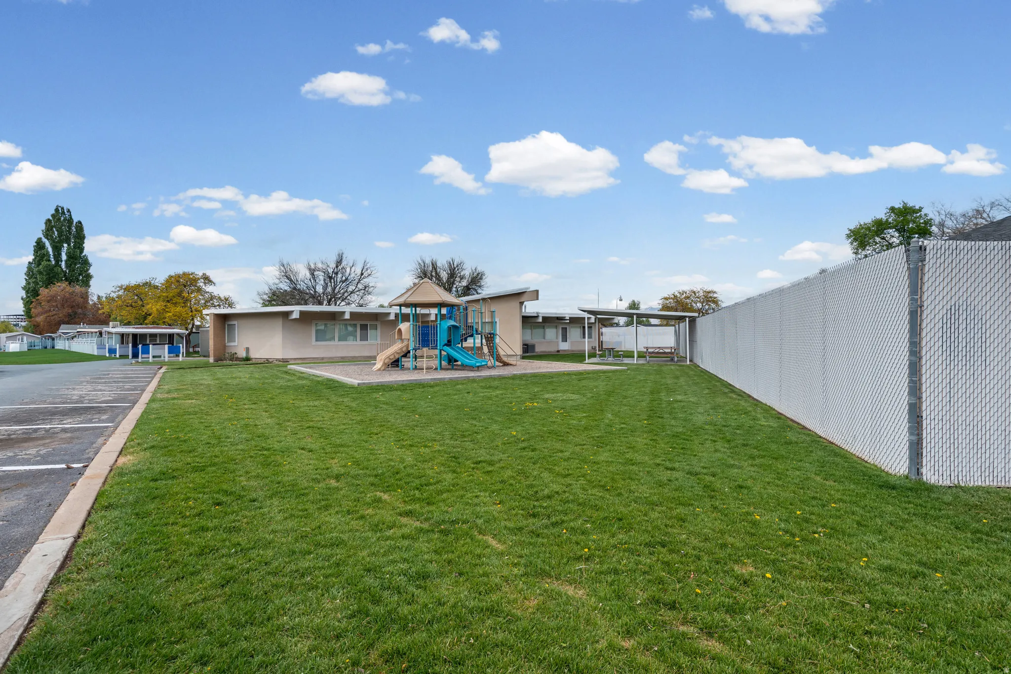 View of green lawn featuring a playground
