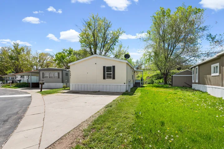 View of front of home with a front lawn and concrete driveway
