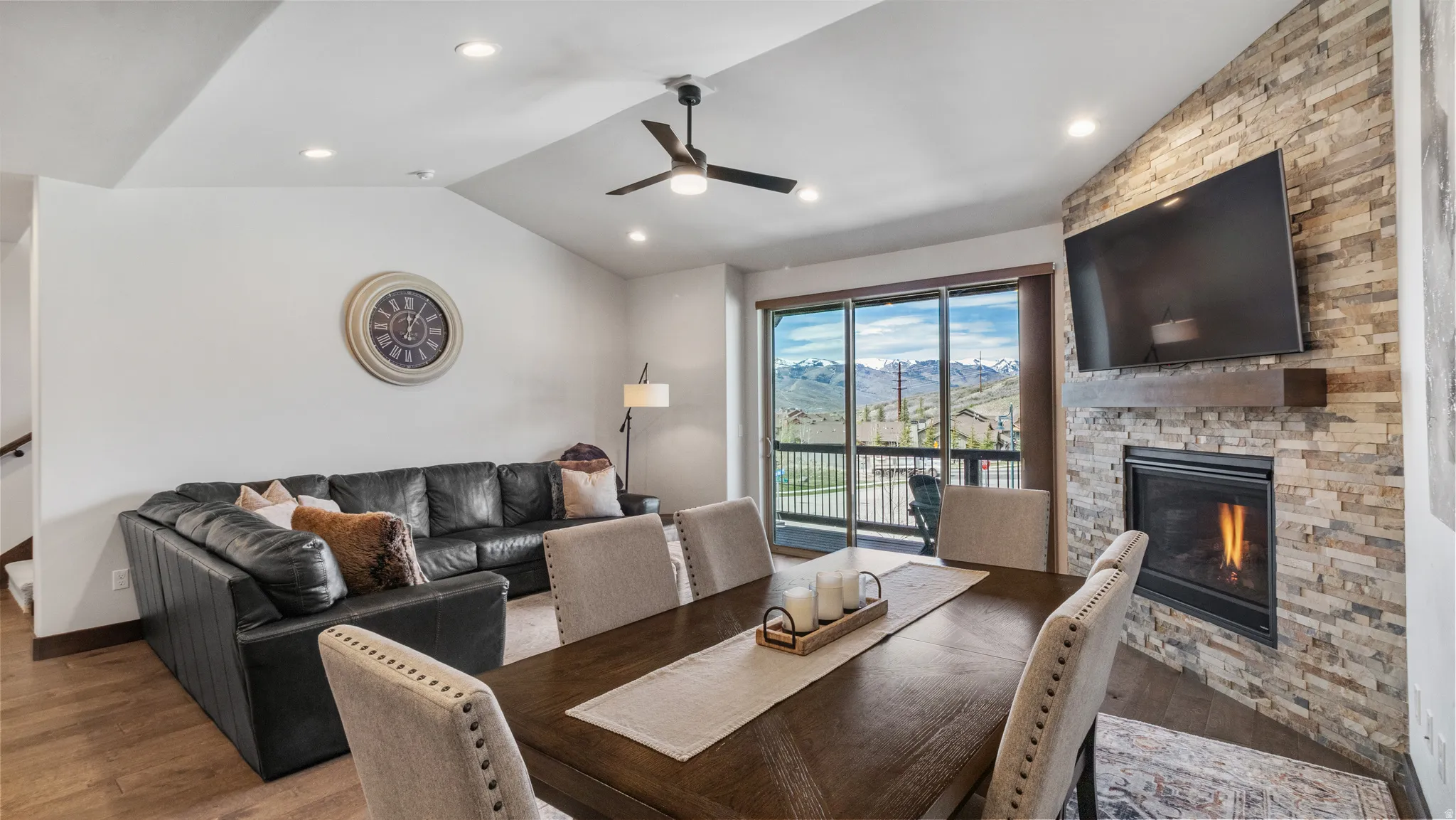 Dining area featuring a fireplace, ceiling fan, wood finished floors, and recessed lighting