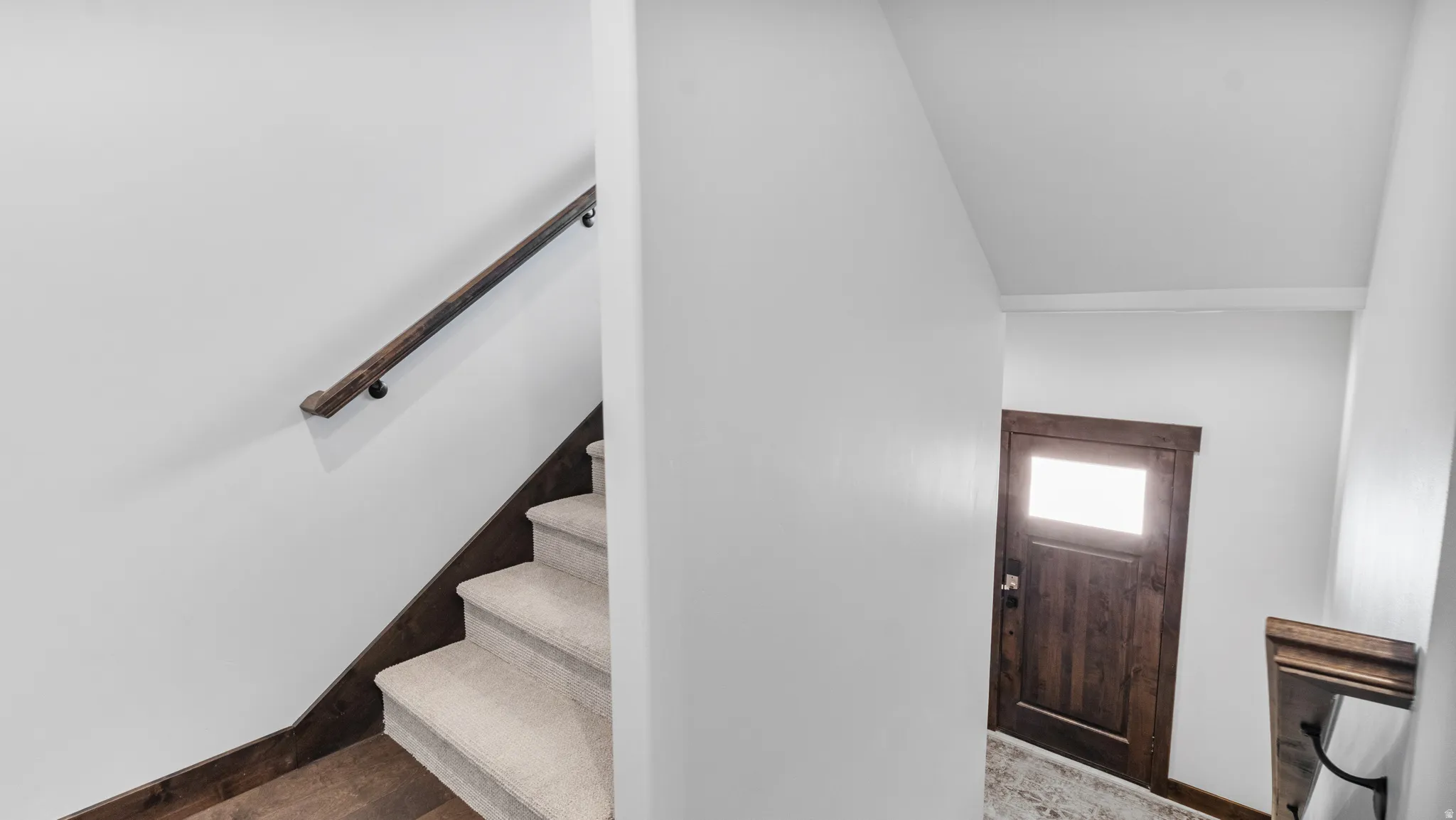 Stairway featuring baseboards and wood finished floors