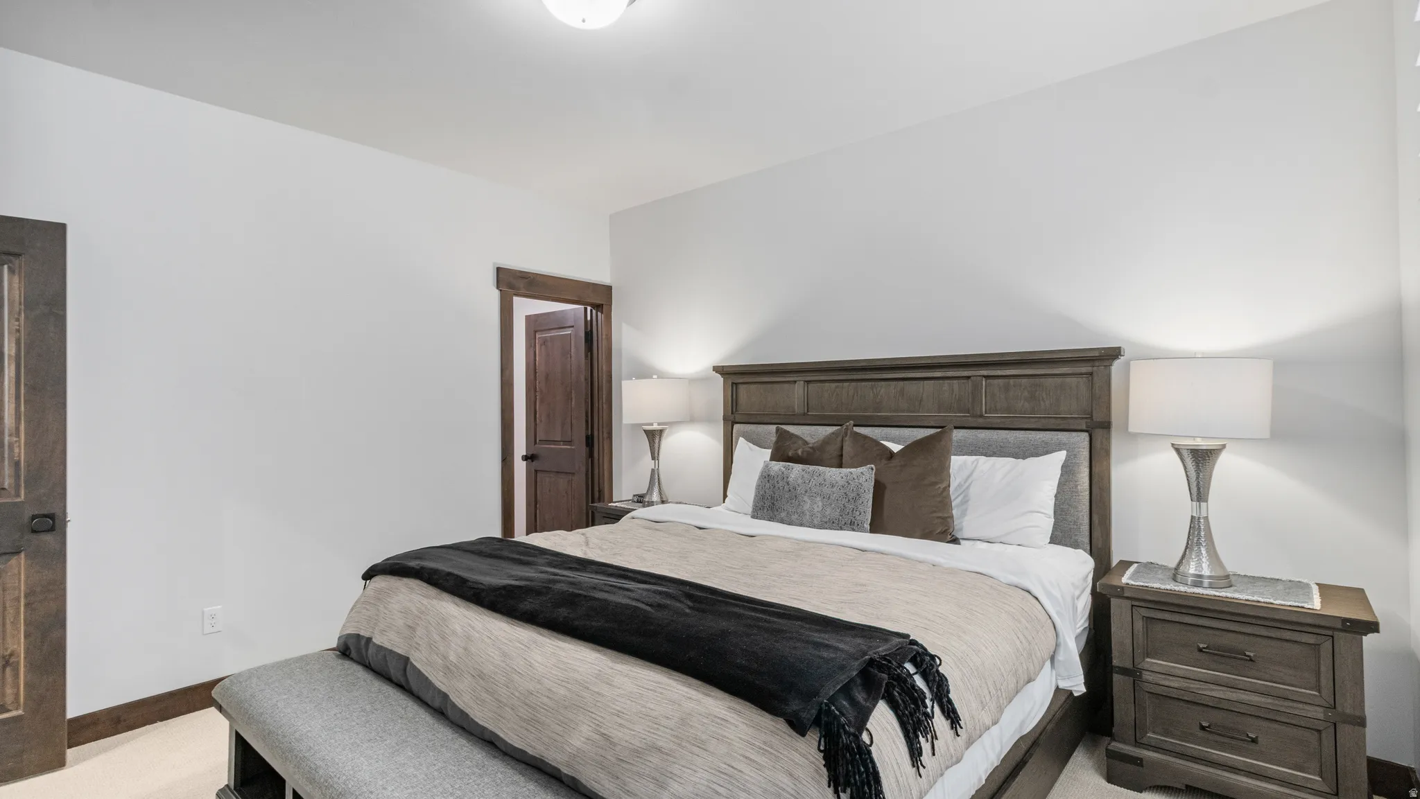 Bedroom featuring light carpet