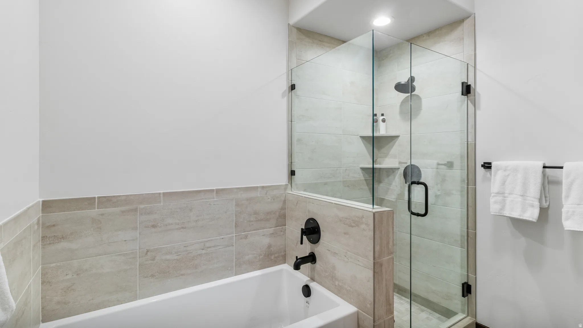 Bathroom with a stall shower and a bath