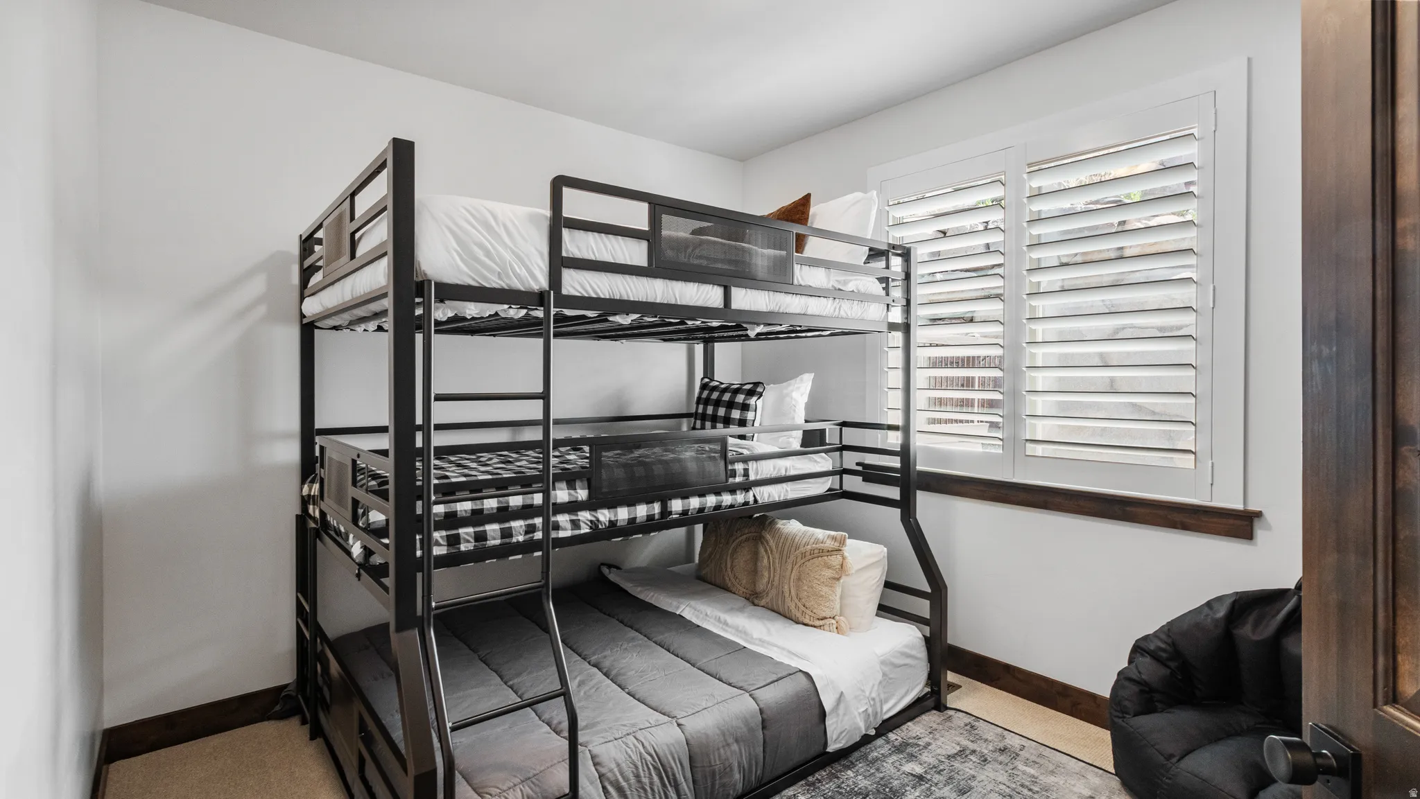 Bedroom featuring light carpet and baseboards