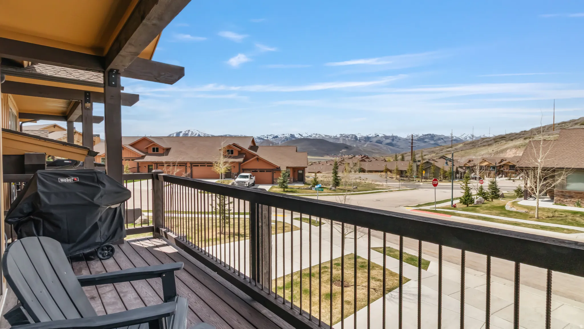 Balcony with grilling area, a mountain view, and a residential view