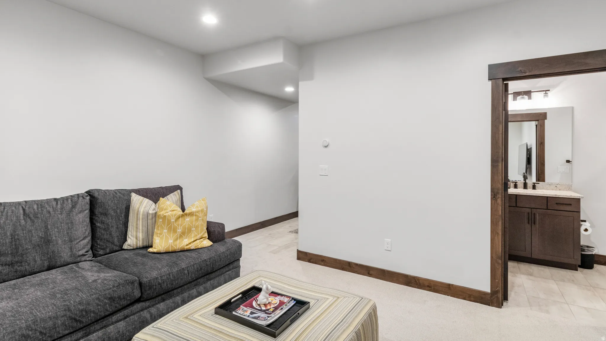 Living area featuring light carpet and recessed lighting