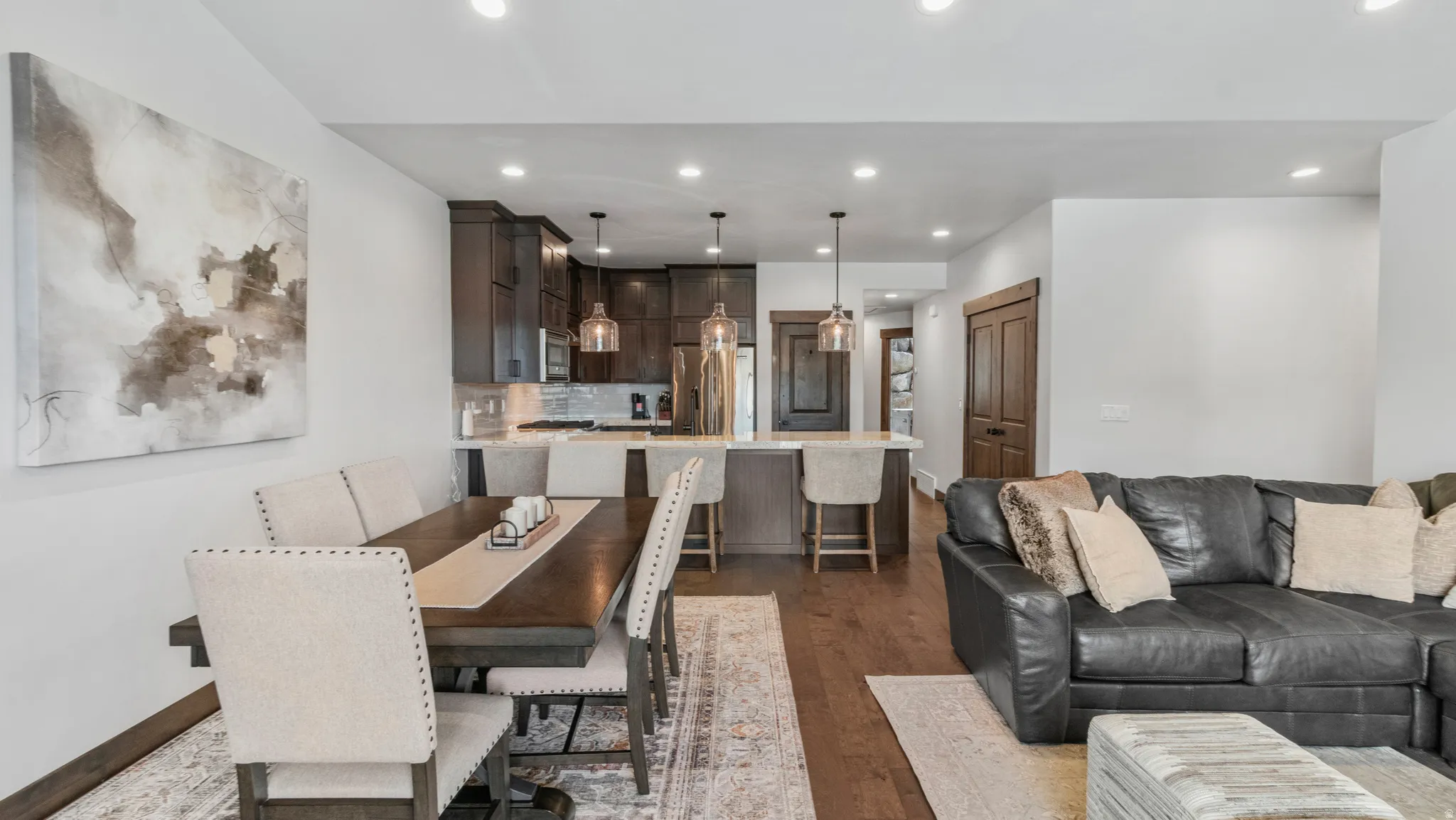 Dining space featuring dark wood-type flooring and recessed lighting