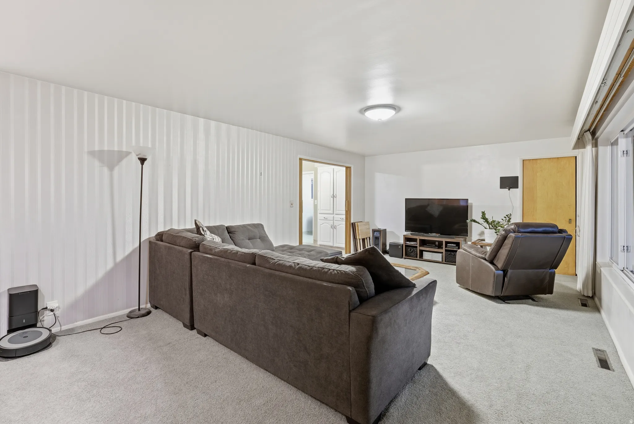 Living area with light colored carpet