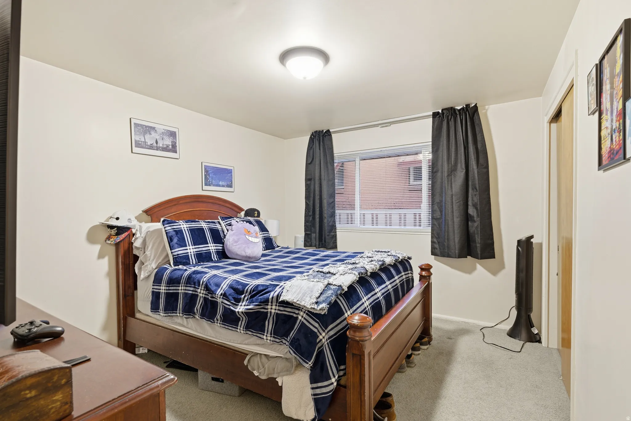 Bedroom with light colored carpet and a closet