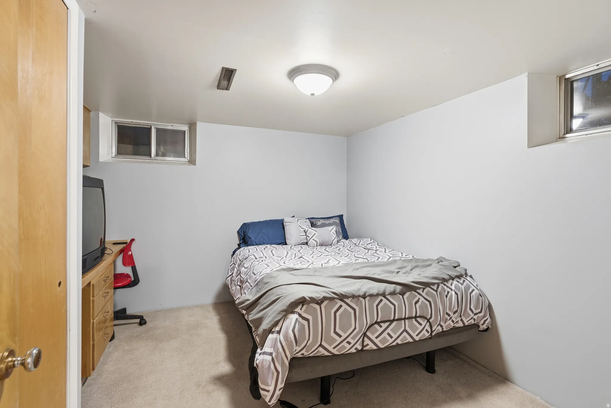 Bedroom with light colored carpet