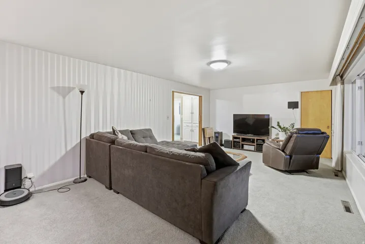 Living area with light colored carpet