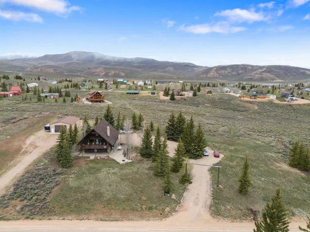 Aerial view of property and surrounding area with mountains