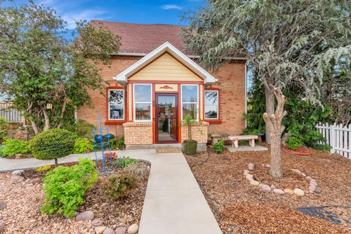 View of front of property with brick siding and a shingled roof