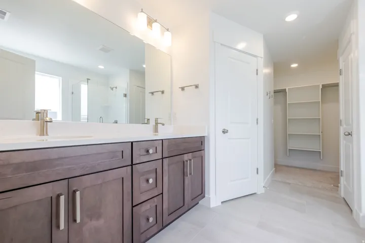Dual vanity with wood-finish cabinetry and quartz countertops
