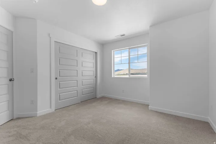 Neutral-toned carpeting complements bright white walls and trim