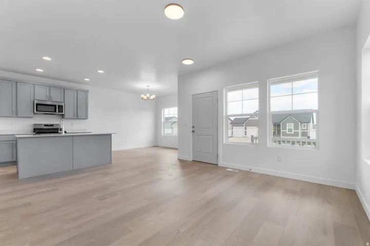Open-concept main living area with wood-finish flooring