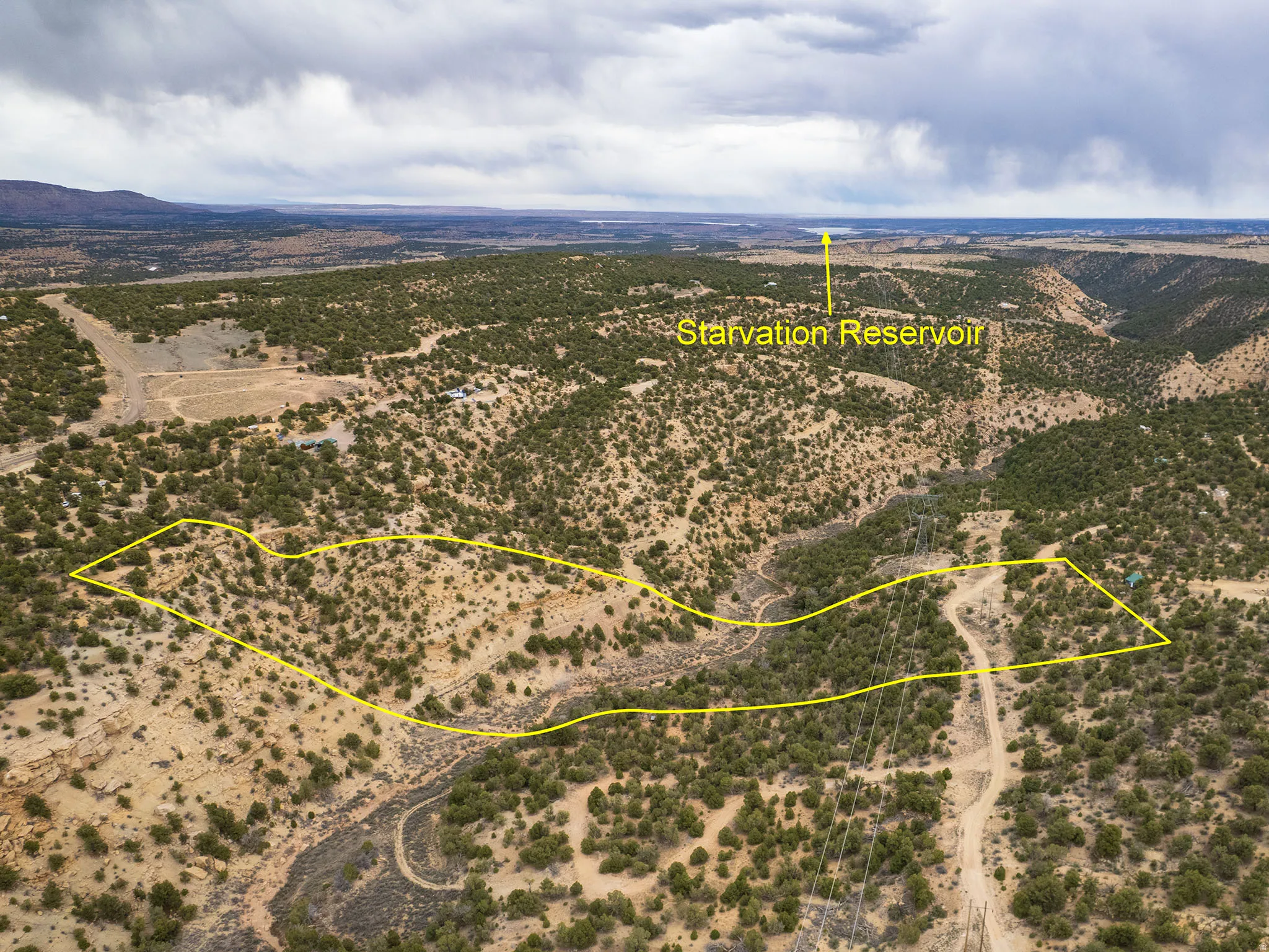Aerial view of sparsely populated area with a desert landscape and property parcel outlined